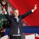 The newly reelected president of Poland, Andrzej Duda, holds his hands up in victory