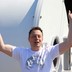 SpaceX's Elon Musk smiles and holds his hands in the air in 2017