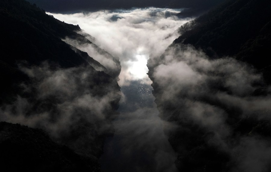 An aerial view of a fog-filled valley