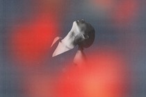A woman surrounded by red lights