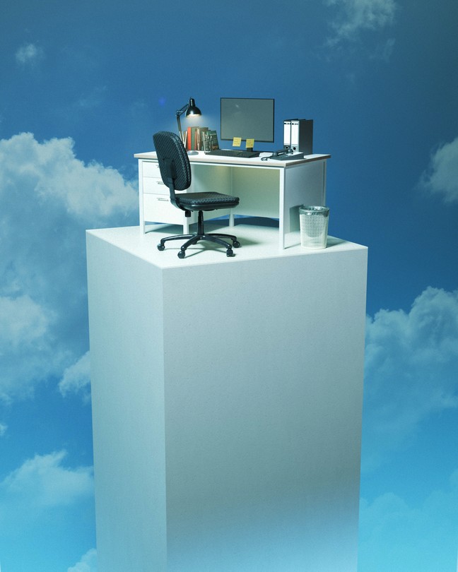 An office desk sits on a pillar high up in the clouds