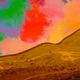 Photo-illustration of a desert hill with a sky full of red, green and yellow patches.