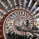 The interior of a bookstore, looking down a tunnel made of spiraling bookshelves