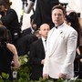 Elon Musk wearing a white suit