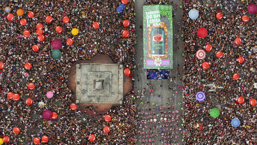 An aerial view of a crowd watching a parade pass by