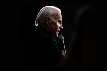 A photo of Biden speaking into a microphone