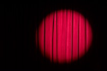 A spotlight on a red curtain