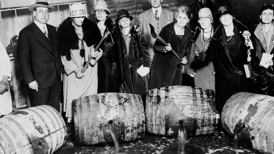 Temperance women breaking barrels of seized liquor during Prohibition.