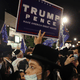 A protester holds up a Trump-Pence sign.