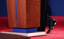 A presidential candidate’s feet at the base of a podium in a presidential debate