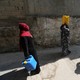 Palestinian women walk after fetching potable water in the Al-Shati refugee camp (also known as Beach Camp) in Gaza City, September 10, 2019.