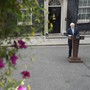 Boris Johnson stands at a lectern on the street outside his 10 Downing Street office.