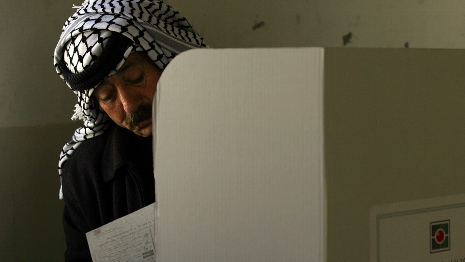 A Palestinian man casts his ballot.