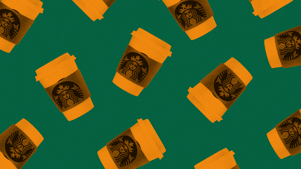 Orange-colored Starbucks cups on a green background