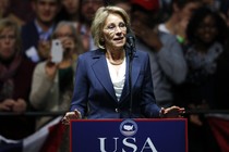 Betsy DeVos stands at a podium.