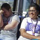 Two women smile on a public bus