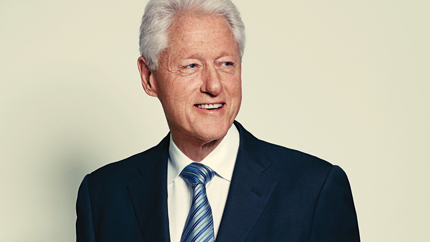 An image of Bill Clinton. He has grey-white hair, and is wearing a blue tie.