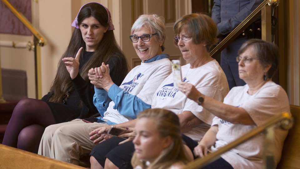 Supporters of Medicaid expansion in Virginia watch the state Senate's vote.