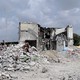 Photo of a destroyed building surrounded by rubble
