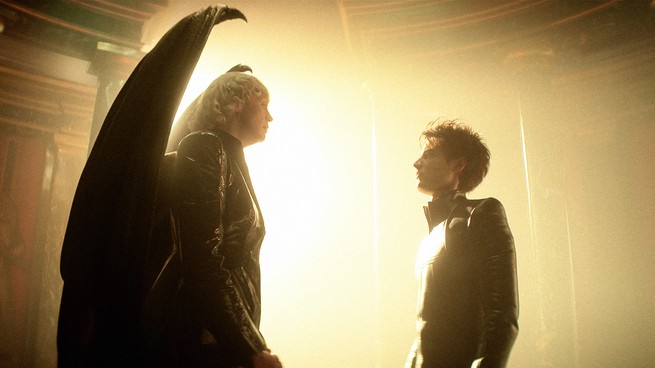 still from "The Sandman" of two characters looking at each other, bathed in light