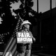 A man holding an American flag and a sign that says "Fair Election"