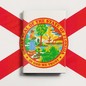 Illustration of the Florida state seal on a book with a red X drawn over it.