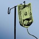 A graphic illustration of a dollar bill hung up like an IV bag