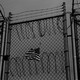 An American flag behind barbed wire fence
