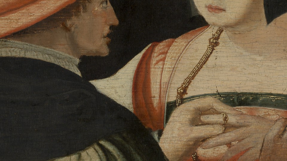 A man placing a wedding ring on a woman’s finger