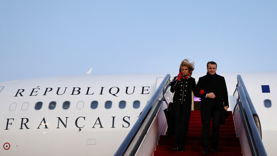President Emmanuel Macron and his wife Brigitte Macron arrive at Beijing Capital Airport.