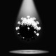 A coronavirus in a spotlight, shadowed