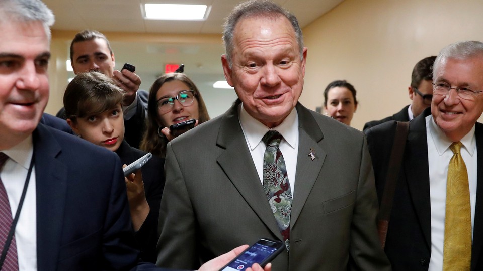 Alabama Republican Senate candidate Roy Moore speaks with reporters.