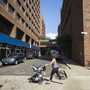A young woman pushes a stroller past Long Island College Hospital in Brooklyn, New York.