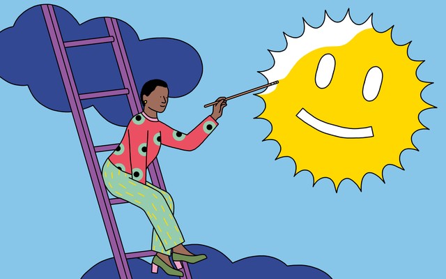 A woman paints a smiley face onto the sun