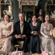 Lydia Rose Bewley, Richard E. Grant, Dakota Johnson, and Yolanda Kettle sitting in a parlor holding teacups in "Persuasion"
