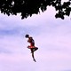 A cheerleader in the air, mid-jump