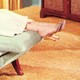 A woman's legs and feet hang over the end of a couch in a therapy office.