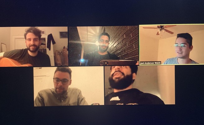A screencap of a Zoom call with five boxes, in each is a man in a nondescript room