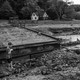 A boy plays near the remainder of a washed-out road near his family's home in Watauga County on September 27, 2024.