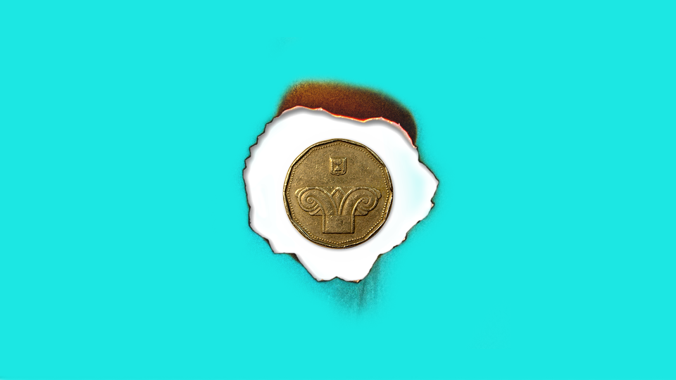 a coin against a burnt paper against a blue background