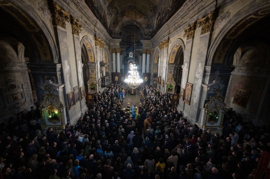 A funeral service takes place inside a large church.