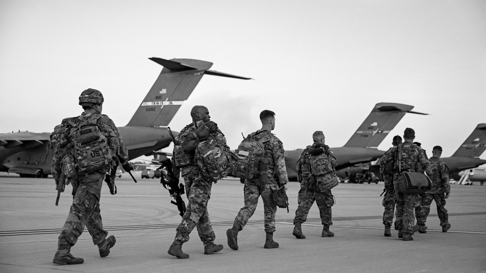 Soldiers of the 82nd Airborne Division walk to board a plane in Fort Bragg, North Carolina, on February 14, 2021 as they are deployed to Europe.