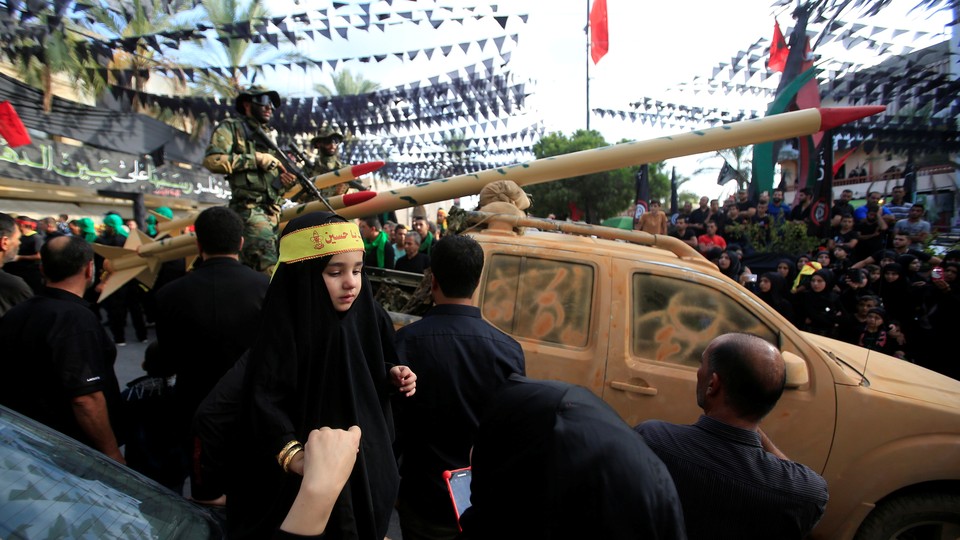 A Hezbollah parade, with a mock rocket launcher, in 2016