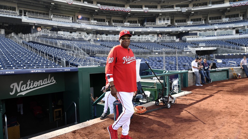 Washington Nationals' Dusty Baker walks on the field during practice at Nationals Park