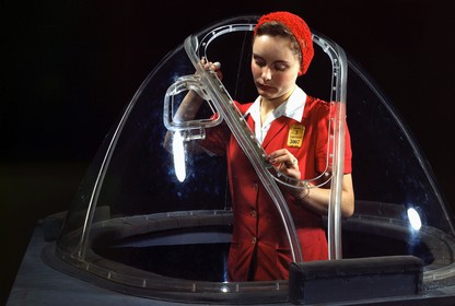 Female worker finishing the plexiglass nose section of a bomber aircraft