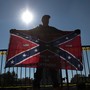 A man holding a Confederate flag