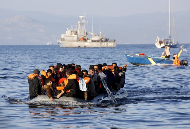 Migrants travel to Lesbos on an overcrowded raft.