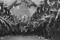 A photo of Hitler walking in a Nazi military parade