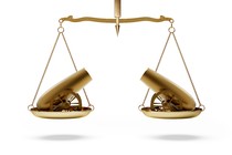 A scale of justice with two cannons pointing at each other