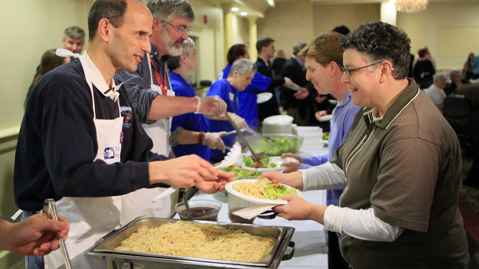 Maine's former governor John Baldacci, left, serves spaghetti at a fundraising event to benefit the Preble Street Resource Center, an agency that helps the homeless, in 2010.